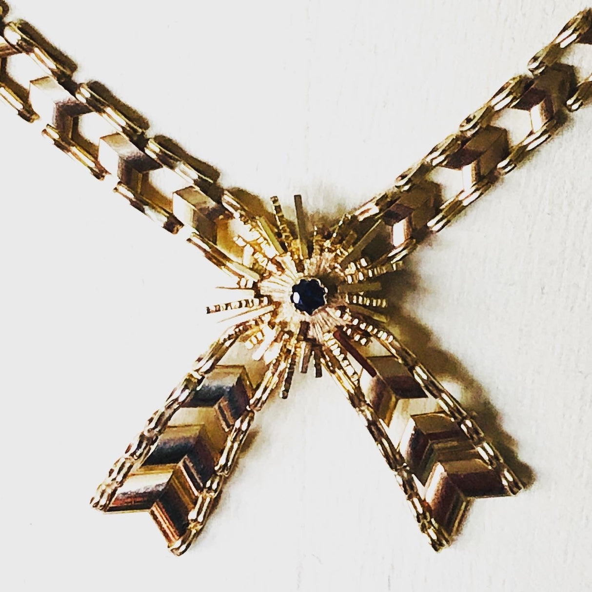 1970s 9k Gold Necklace with a Tied Ribbon Design Set with a Sapphire The Vintage Jewellery Company