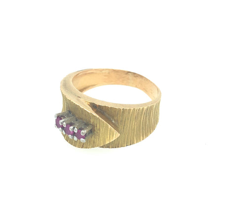 Vintage gold wrapover belt ring with engraved detail and set with three rubies The Vintage Jewellery Company