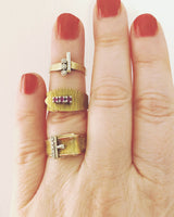 Vintage gold wrapover belt ring with engraved detail and set with three rubies The Vintage Jewellery Company